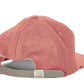 Coral baseball cap with an adjustable strap.